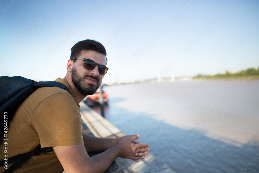 Handsome black bearded man as a tourist exploring the city. Portrait of a european handsome man.