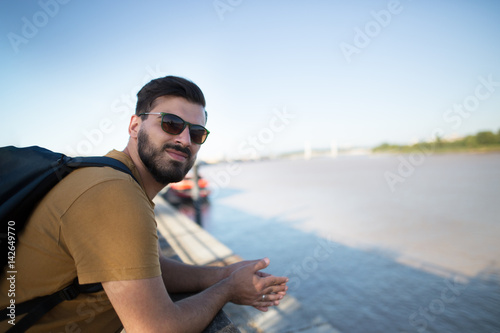 Handsome black bearded man as a tourist exploring the city. Portrait of a european handsome man.