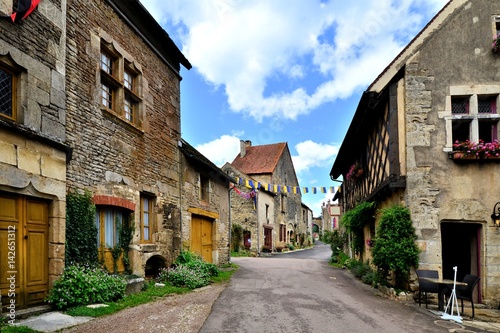 Picturesque lane in a medieval village in Burgundy, France © Jenifoto