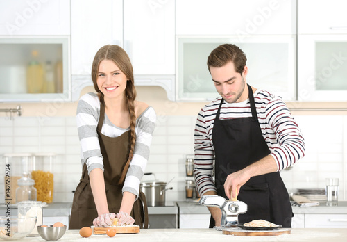 Young couple preparing past...
