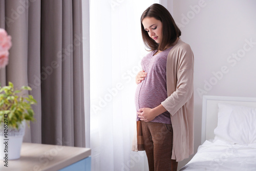 Beautiful pregnant woman st...
