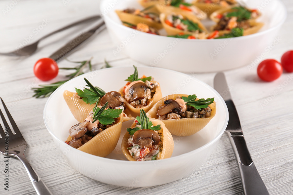 Plate with stuffed pasta on wooden table Plate with stuffed pasta on wooden table
