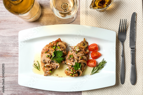 Tasty chicken marsala on plate photo