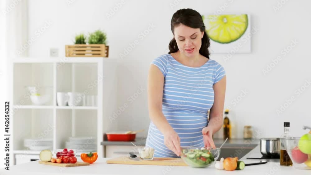 pregnant woman cooking vegetable salad at home pregnant woman cooking vegetable salad at home