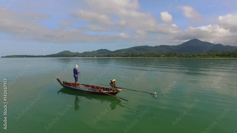 Aerial: Fisherman with Fishing Net on Thai Boat in Sea