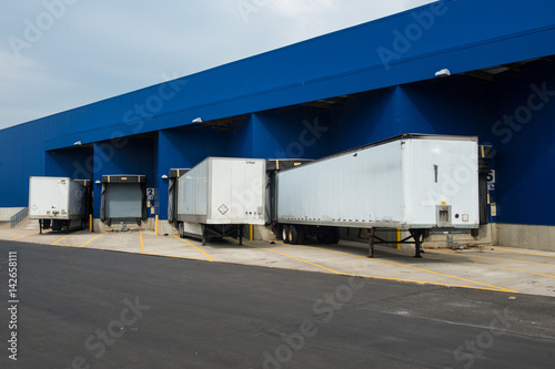 Transportation service delivery station. Big distribution warehouse with gates for loads and trucks.