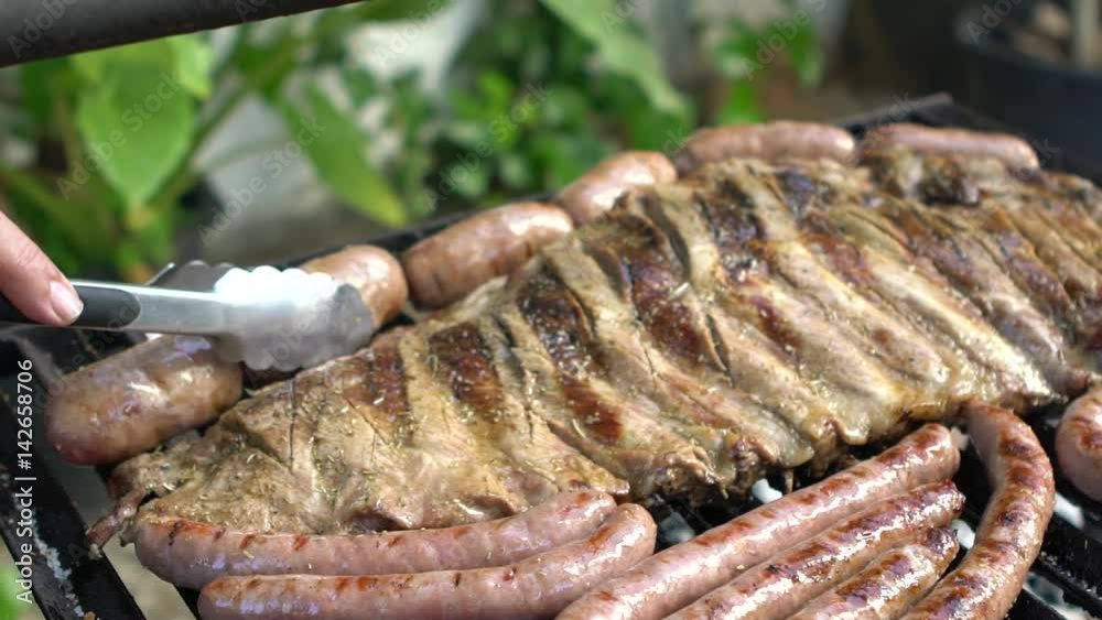 Slow motion Cooking barbecue with delicious grilled meat. Slowmo fatty BBQ of Ribs Pork and Sausages, spanish chorizo, Chistorra, Morcilla, Blood sausage being fried on a charcoal grill -Dan Slow motion Cooking barbecue with delicious grilled meat. Slowmo fatty BBQ of Ribs Pork and Sausages, spanish chorizo, Chistorra, Morcilla, Blood sausage being fried on a charcoal grill -Dan