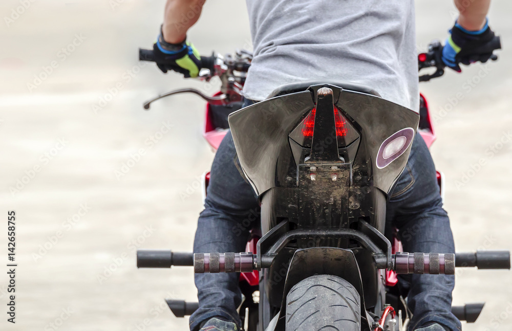 Naklejka premium cropped image of man driving motocycle