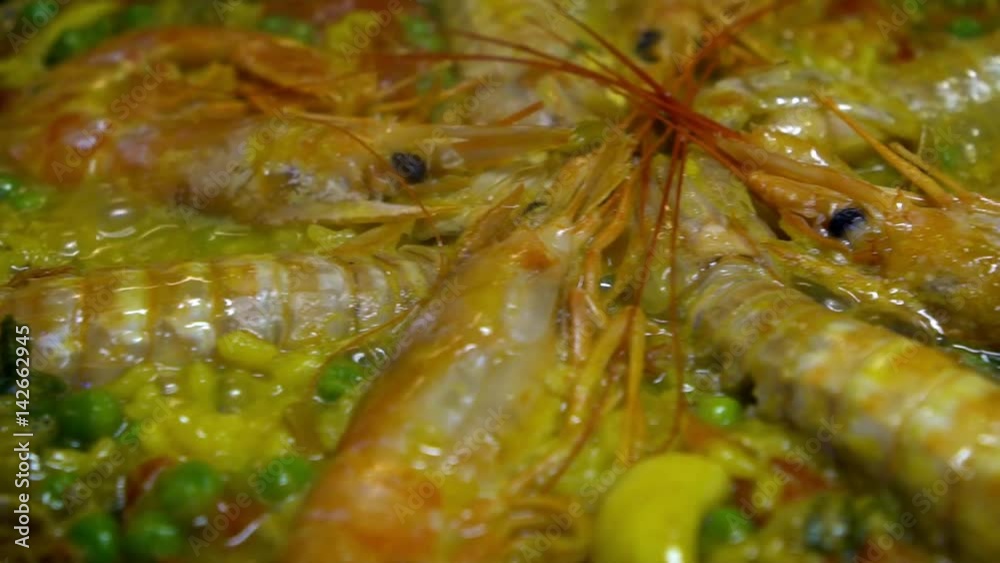 Slow motion Chef cooking Paella Bubbling With Muscles Clams And Assorted Seafood. Slowmo preparing tipical delicious Spain food Tapa. Tasty Spanish dish-Dan Slow motion Chef cooking Paella Bubbling With Muscles Clams And Assorted Seafood. Slowmo preparing tipical delicious Spain food Tapa. Tasty Spanish dish-Dan