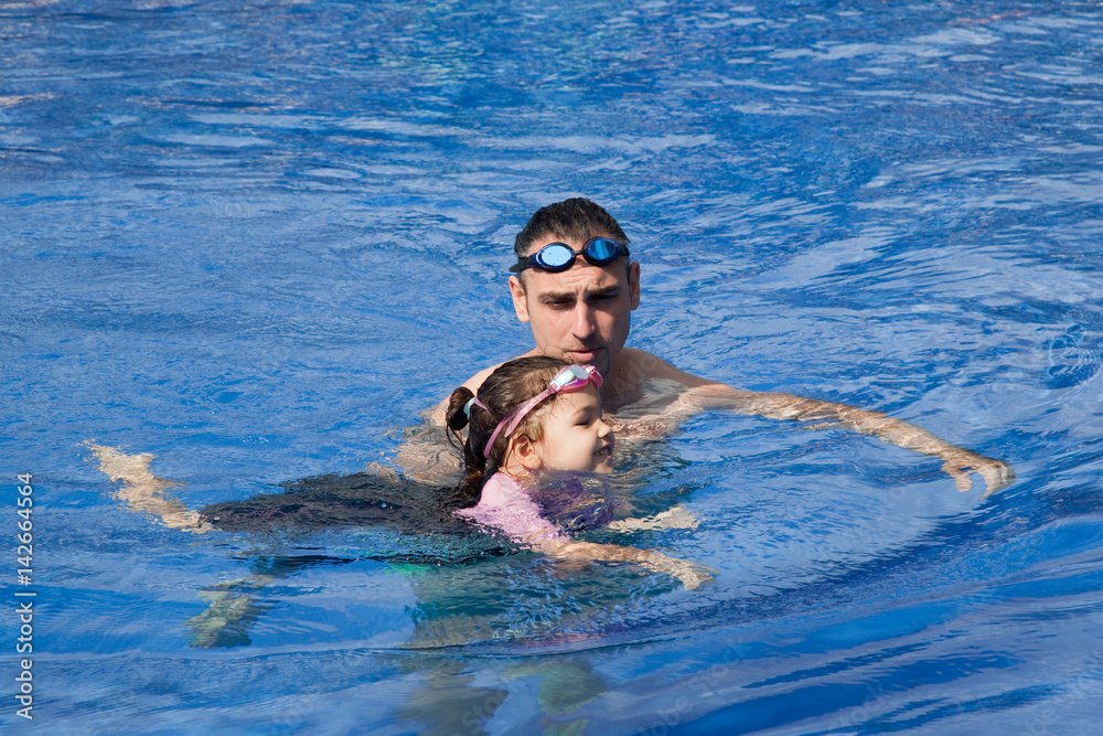 Father and Daughter  In Swimming Pool 