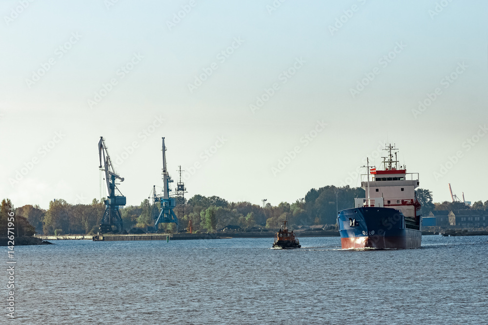 Blue cargo ship leaving the port of Riga