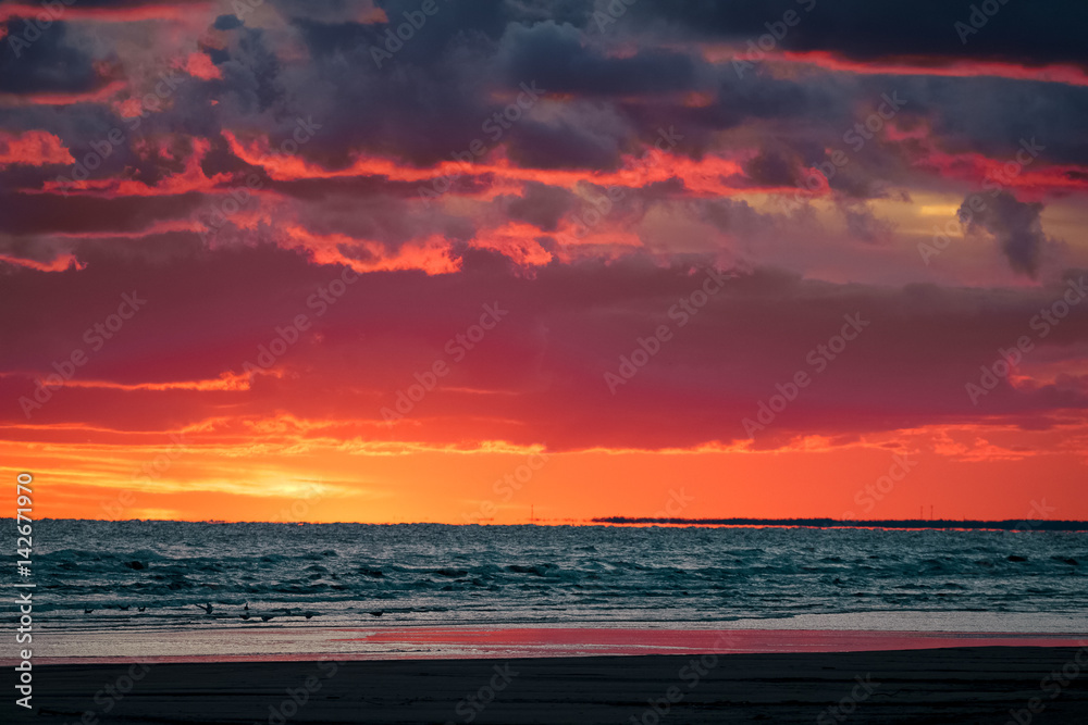 Red cloudy sunset sky over the Baltic sea
