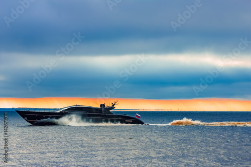 Black elite speed motor boat moving fast from Baltic sea © InfinitumProdux