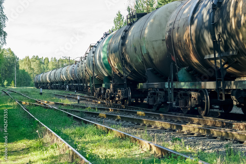 Tank wagons with oil. Freight train in forest