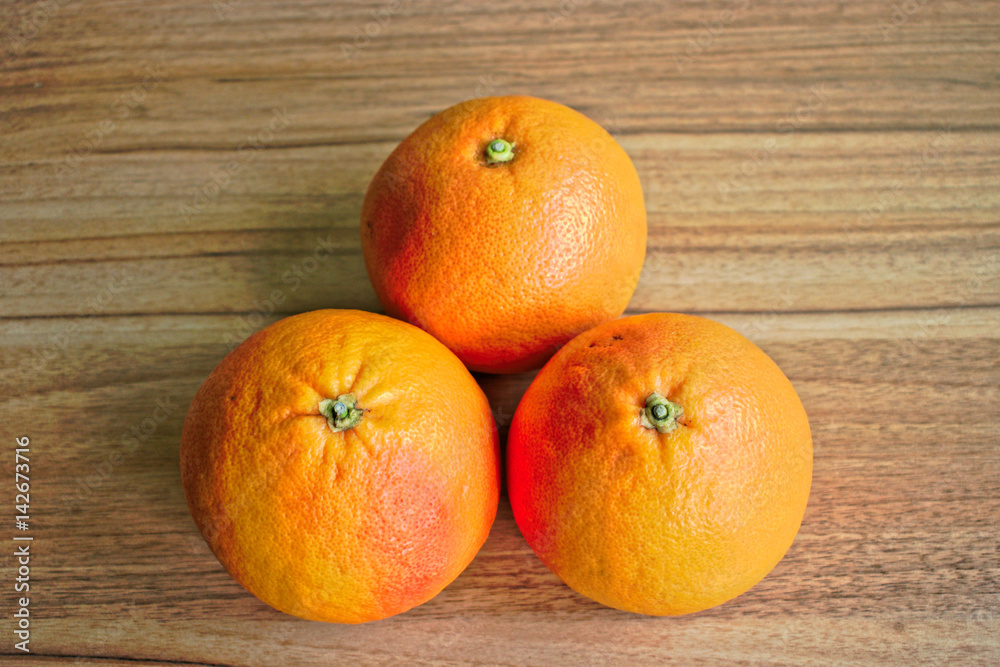 Red grapefruits on a wooden table Red grapefruits on a wooden table