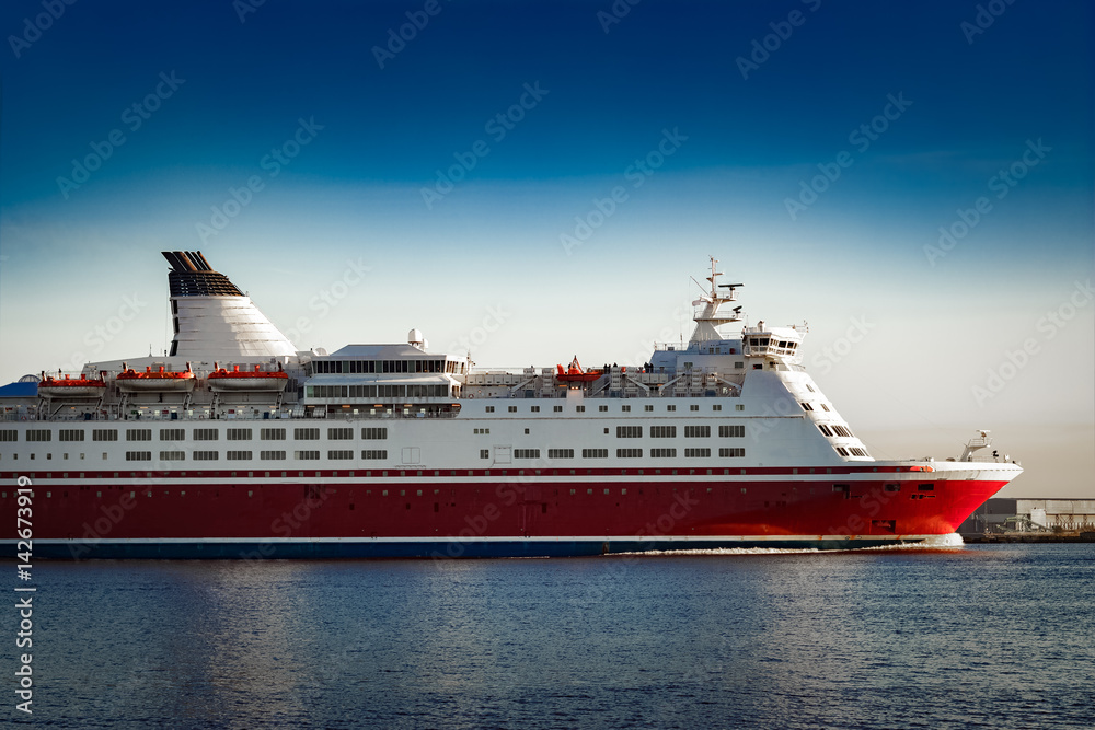 Red cruise liner. Passenger ferry ship sailing in still water