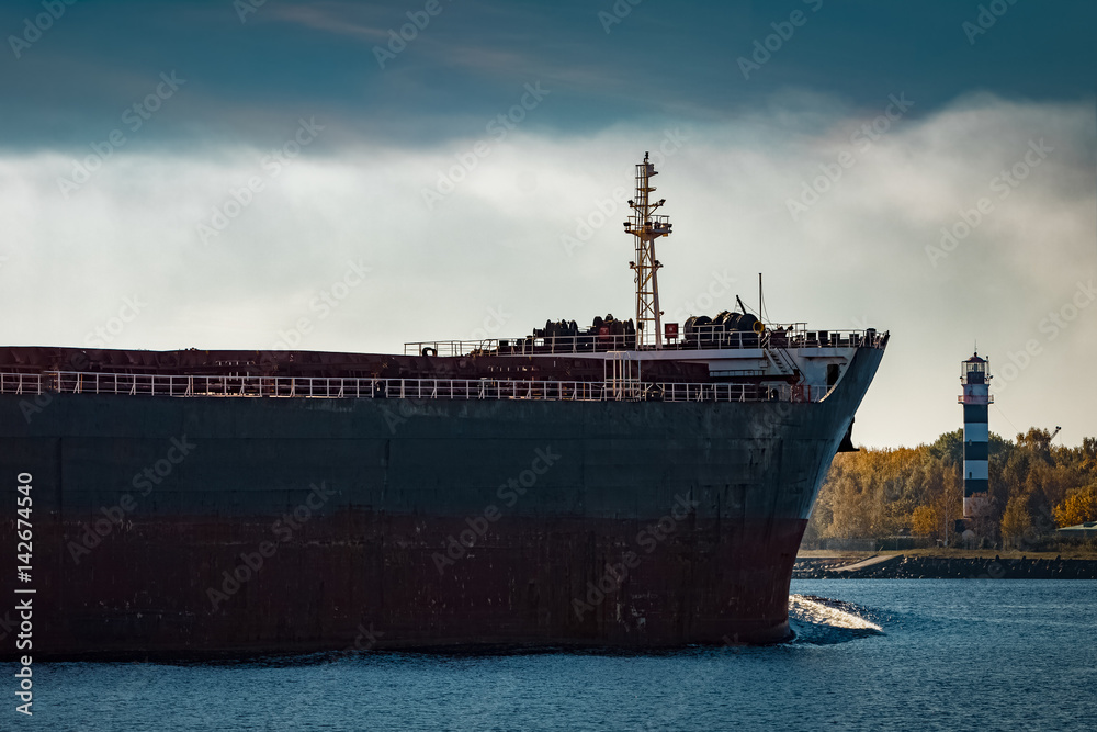 Fototapeta premium Black cargo ship's bow entering Riga, Europe