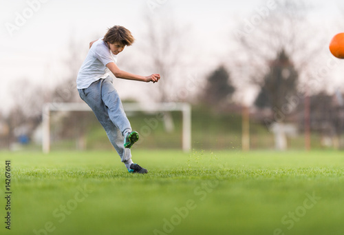 Kids soccer football - children player on soccer field