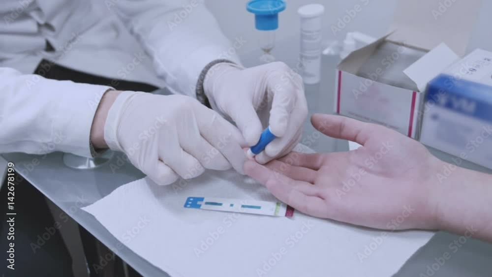 Doctor taking blood sample from male hand at lab. Hiv testing blood. Nurse puncture finger blood test. Man donate blood finger test in lab. Medical hiv test. Doctor using lancelet for medical test Doctor taking blood sample from male hand at lab. Hiv testing blood. Nurse puncture finger blood test. Man donate blood finger test in lab. Medical hiv test. Doctor using lancelet for medical test