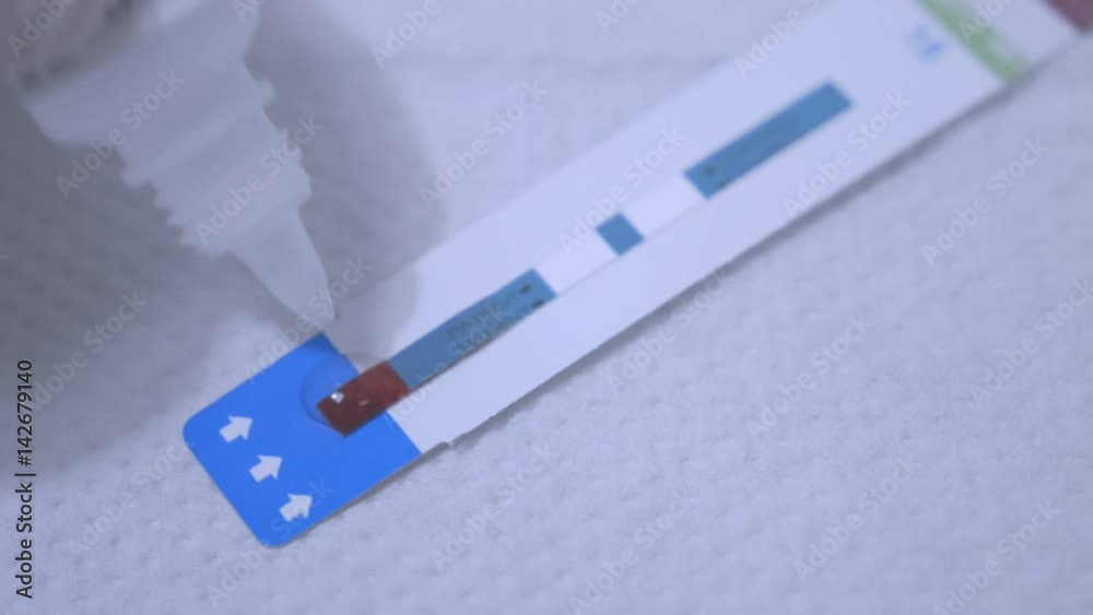 Drop reagent on test strip. Close up of testing blood sample. Hiv