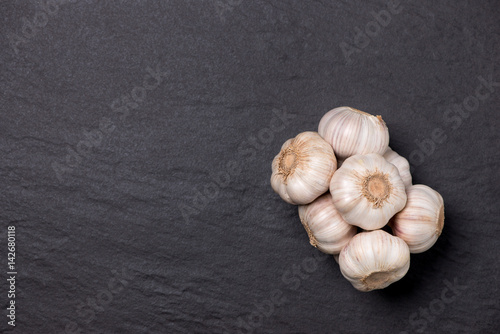Fresh garlic. Garlic Bulb on black stone table.