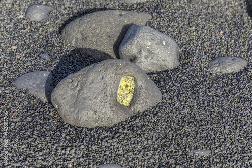 olivine gemstone also called peridot at volcanic beach