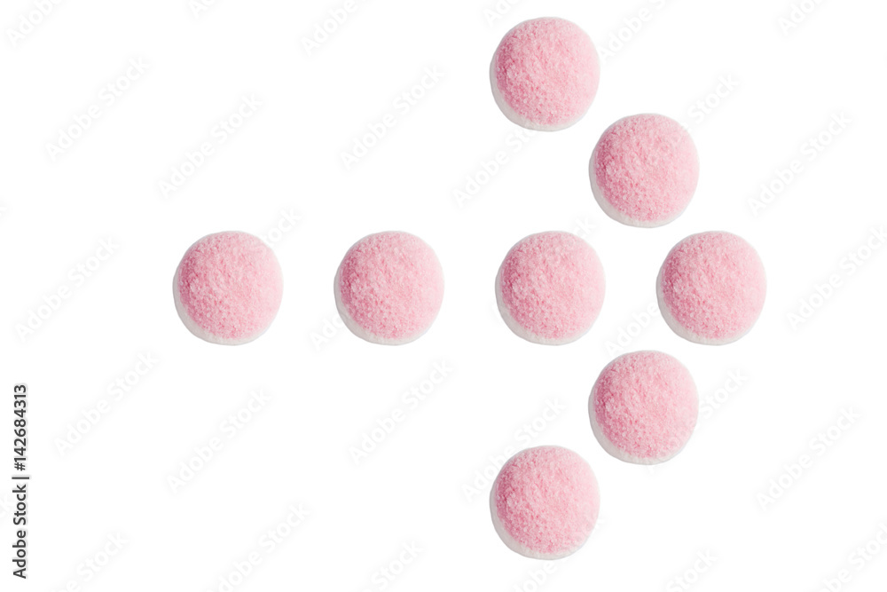 The arrow pointer of pink and white candies and jelly on white background The arrow pointer of pink and white candies and jelly on white background