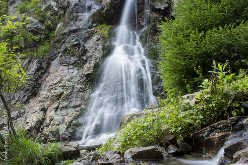 Waterfall on mountain river in Carpathian Mountains , Romania