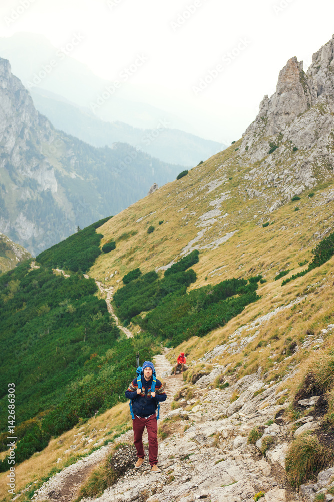 Hikers making their way up a rugged mountain trail