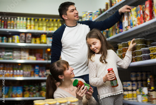 Ordinary family of three buying canned food