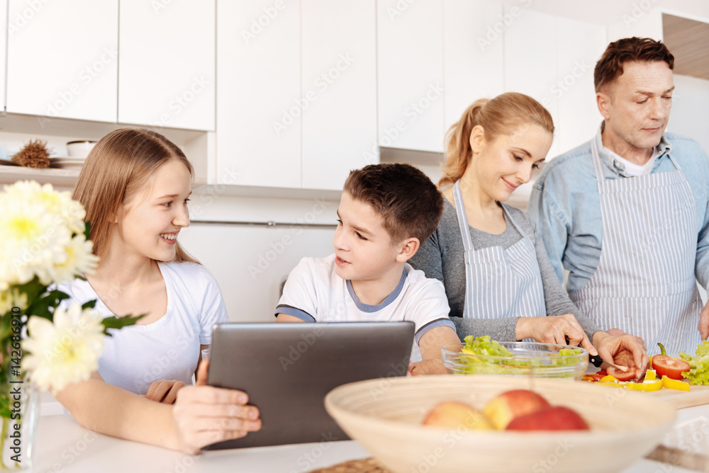 Cheerful siblings resting in the kitchen