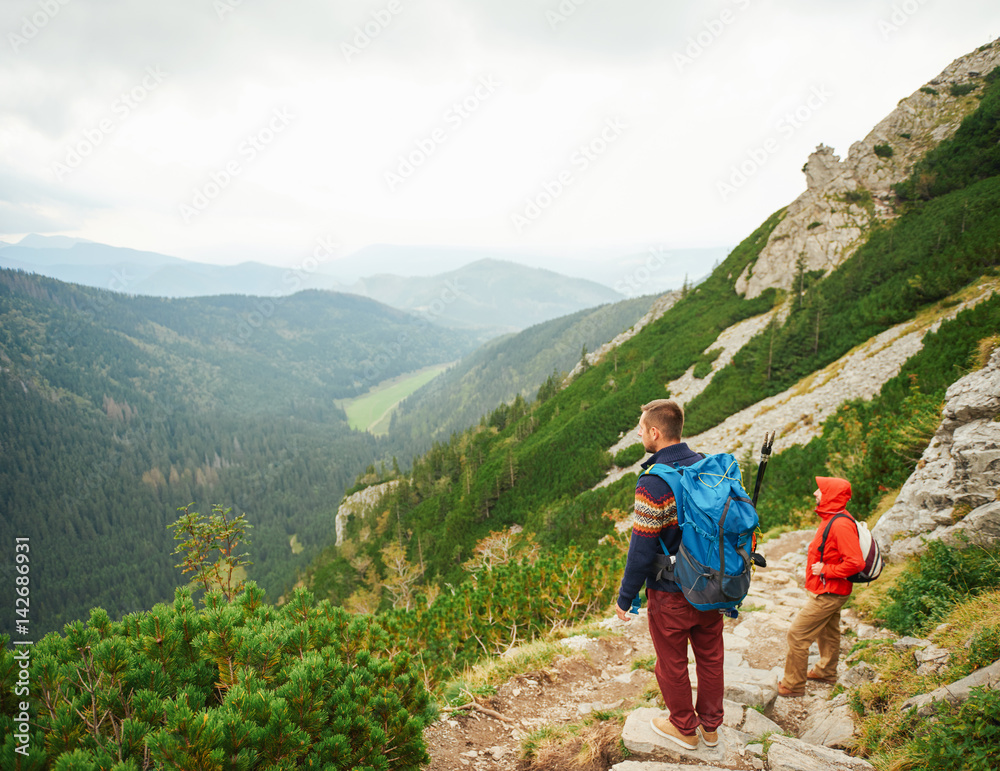 Hikers taking in the view from a rugged mountain trail