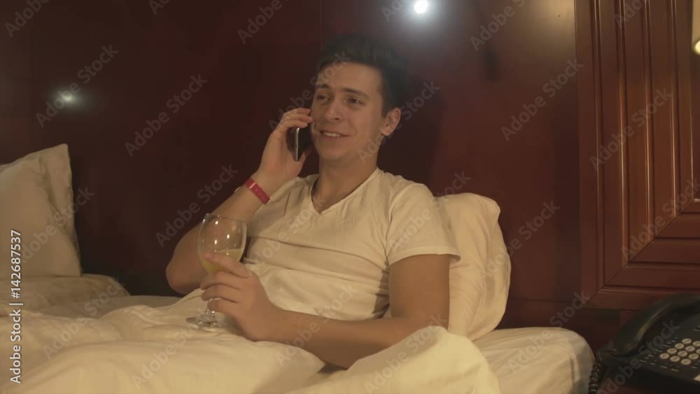 Handsome young man drinking juice at home Handsome young man drinking juice at home