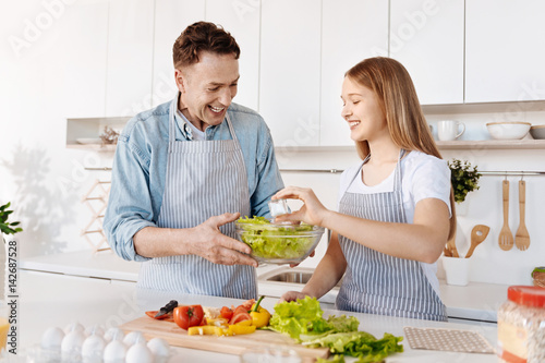Positive smiling father and daughter having fun in the kitchen © Viacheslav Yakobchuk