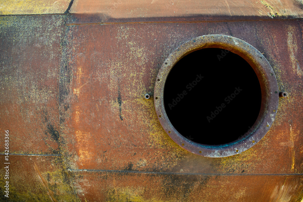 opened rusty manhole on orange fuel tank