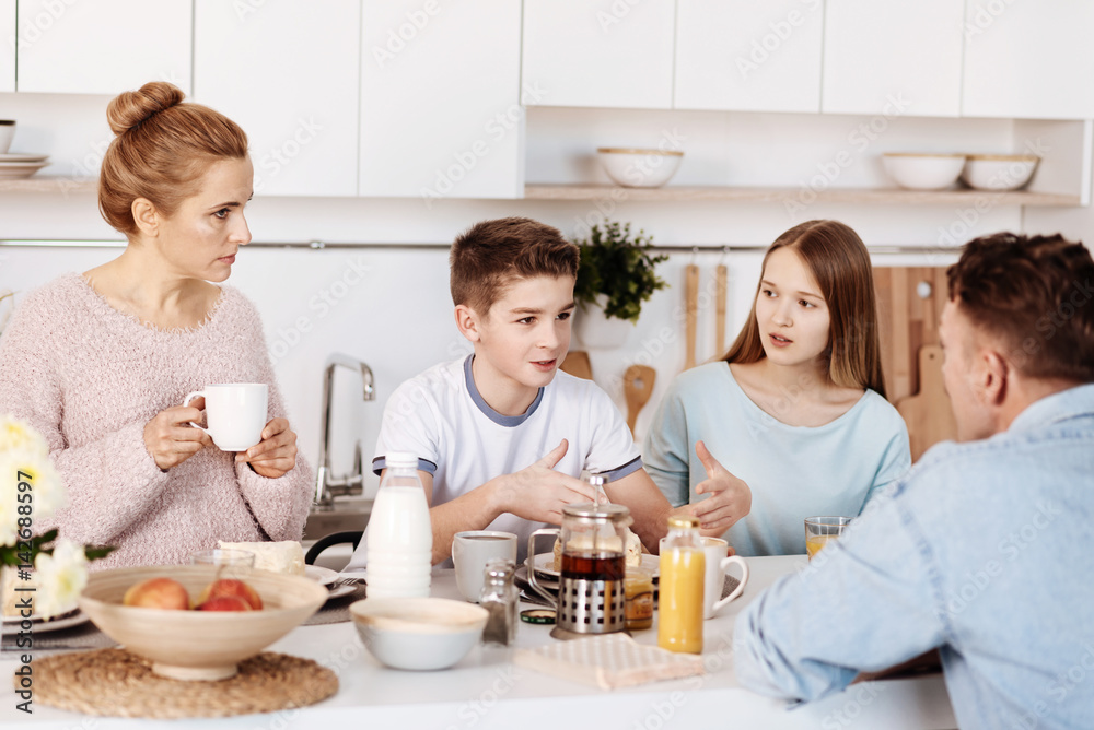 Pleasant family having lively conversation Pleasant family having lively conversation