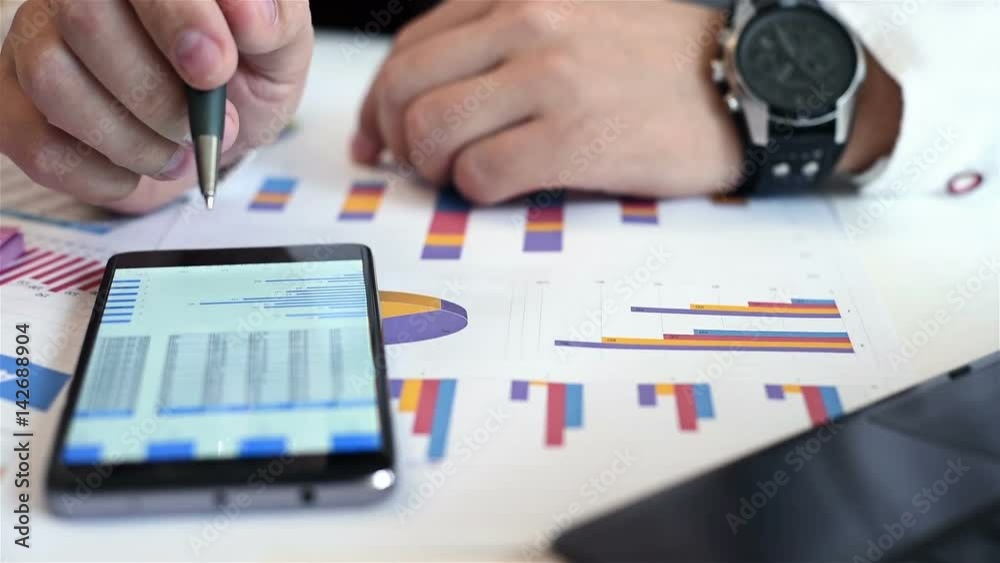 Businessman Working On Financial Graph On Smart Phone. Close Up