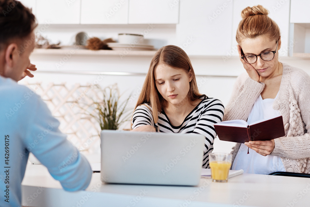 Troubled mother checking results of her daughter at school Troubled mother checking results of her daughter at school