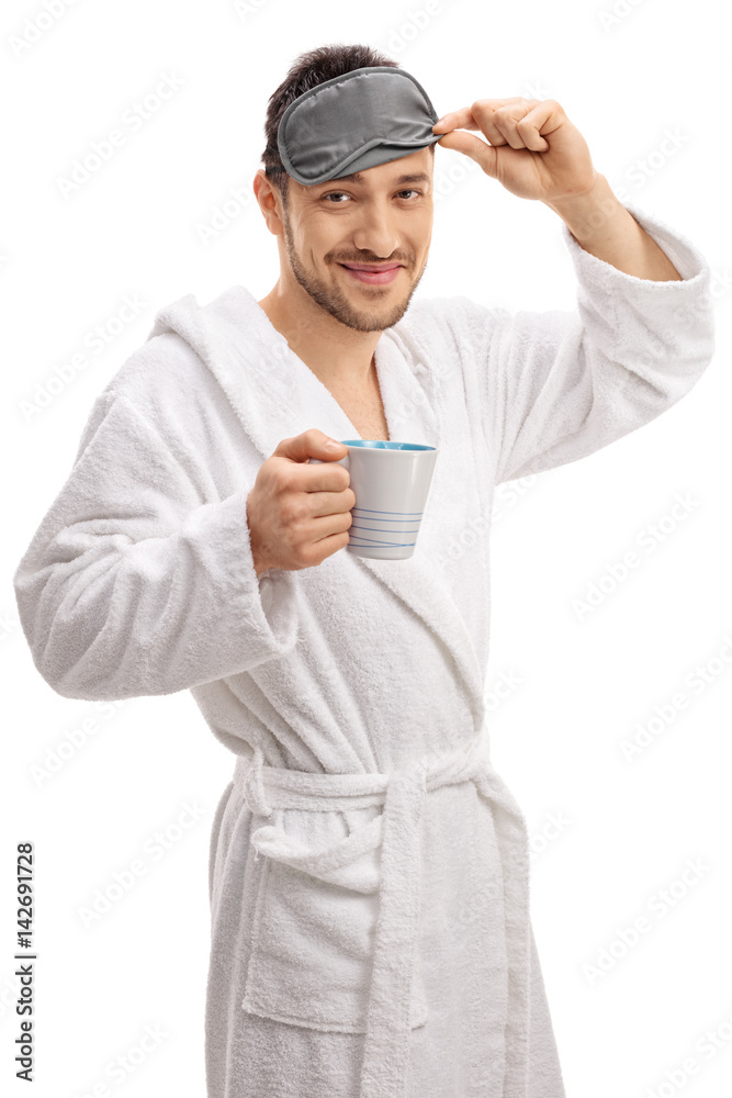 Guy with bathrobe and sleeping mask holding a cup Guy with bathrobe and sleeping mask holding a cup