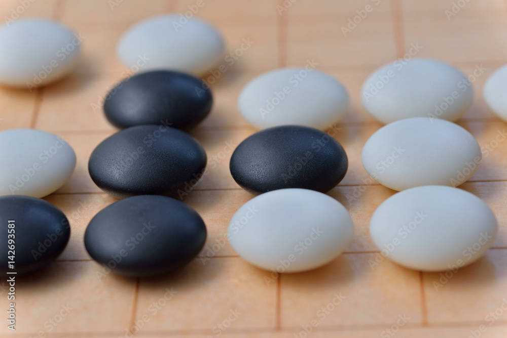 GO game. GO is an abstract strategy board game for two players, in which the aim is to surround more territory than the opponent. GO game. GO is an abstract strategy board game for two players, in which the aim is to surround more territory than the opponent.