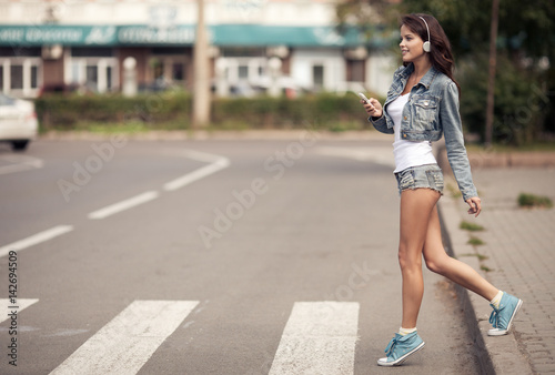 Image of young happy woman, listening music and having fun on the street. Lifestyle. Outdoor. © yuriyzhuravov