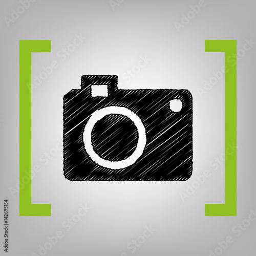 Digital camera sign. Vector. Black scribble icon in citron brackets on grayish background.