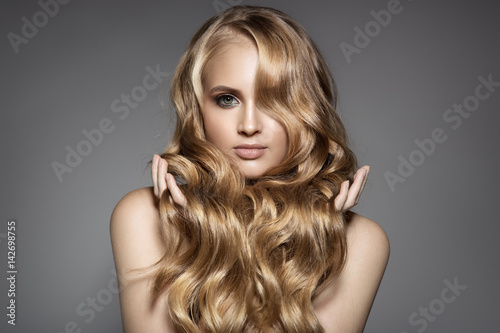Portrait Of A Beautiful Young Blond Woman With Long Wavy Hair