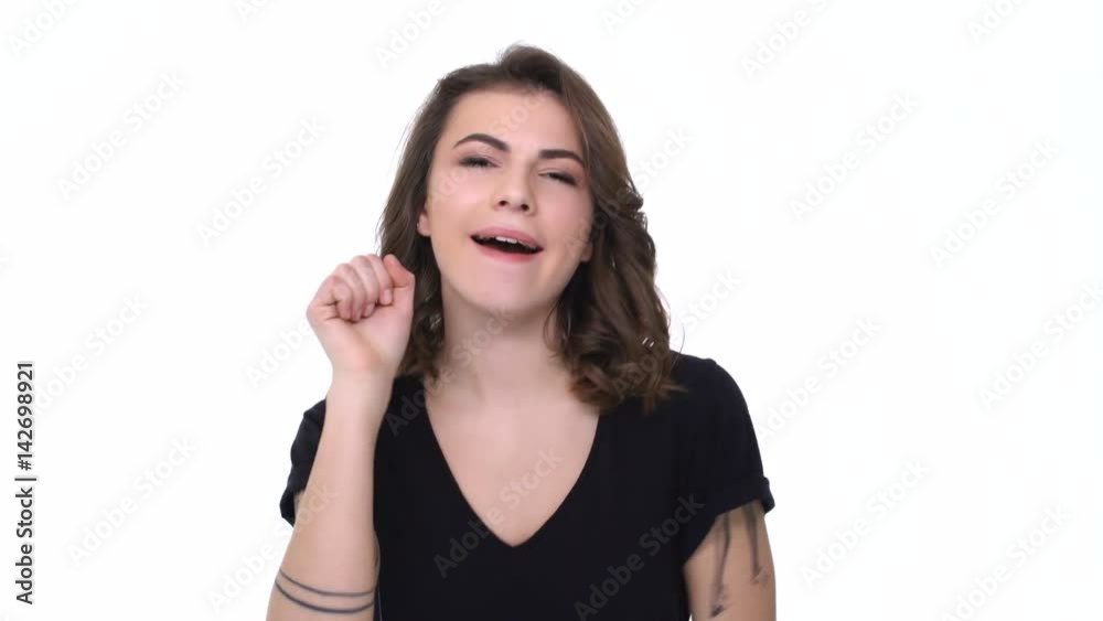 Attractive young woman gesturing and flirting with camera isolated Attractive young woman gesturing and flirting with camera isolated