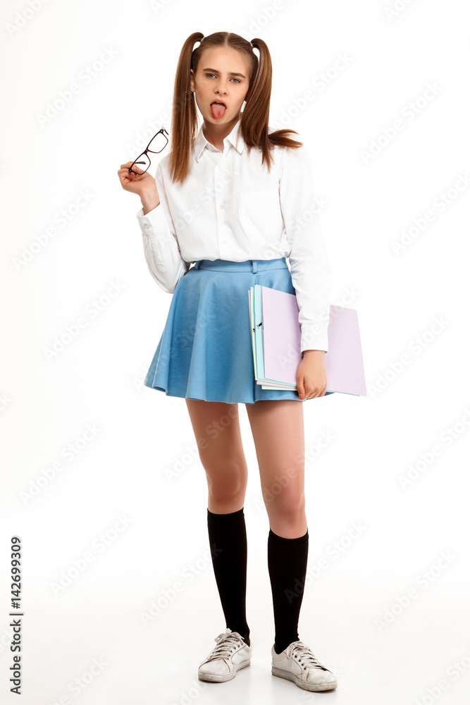 Young emotional pretty girl in uniform posing over white background. Young emotional pretty girl in uniform posing over white background.