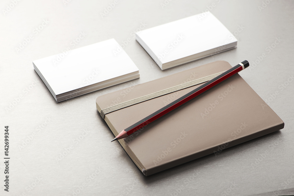 Pencil, business card and notepad on gray background. Business. Pencil, business card and notepad on gray background. Business.