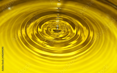 A droplet of water with yellow  gold waves