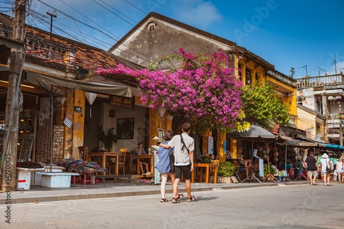 HOI AN, VIETNAM - MARCH 15, 2017: Group of people travel Hoian old town, ancient house, country heritage, city friendly with environment, walk, bicycle or pedicab on street, traveller visit at Vietnam © Big Pearl