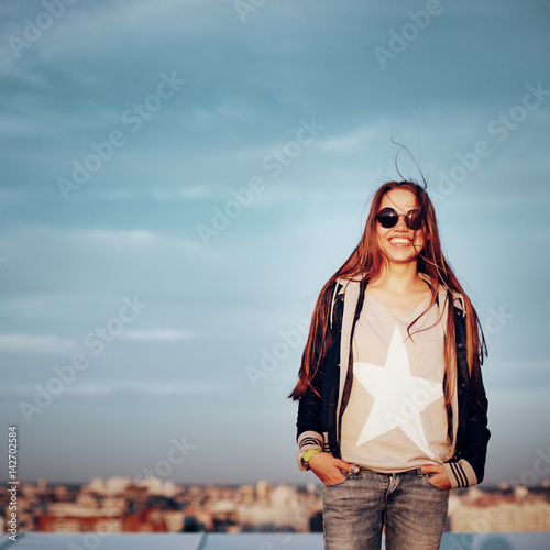 Young bright woman on a roof
