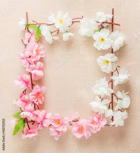 Frame of spring flowers on a wooden ,with space for text ,spring or summer theme